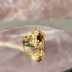 Step back in time with our exquisite Vintage 10k Gold Freeform Ring, featuring a mesmerizing Pear Cut Garnet. This timeless piece of fine jewelry exudes elegance and charm, perfect for adding a touch of vintage glamour to any ensemble. Crafted with care and attention to detail, this ring boasts a unique freeform design that sets it apart from the ordinary. The lustrous 10k gold band adds a luxurious touch, while the pear-cut garnet gemstone sparkles with rich hues of red, reminiscent of a deep s Heirloom Teardrop Diamond Ring For Formal Occasions, Formal Heirloom Teardrop Diamond Ring, Fine Jewelry Yellow Gold Topaz Teardrop Ring, Fine Jewelry Yellow Gold Topaz Ring With Teardrop, Teardrop Gemstone Ring For Formal Occasions, Elegant Gold Topaz Ring With Polished Finish, Classic Marquise Topaz Ring For Gift, Fine Jewelry 14k Gold Pear-shaped Ruby Ring, Formal Ruby Ring With Diamond Cut In Yellow Gold