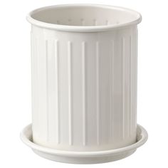 a white plastic trash can sitting on top of a table