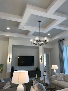 a living room filled with furniture and a flat screen tv mounted on the wall above it