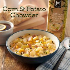 a bowl of corn and potato chowder next to a bottle of soup