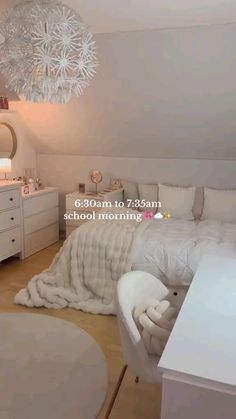 a bedroom with white furniture and a chandelier hanging from it's ceiling