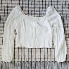 Off White Crop Shirt. Back Is Smocked. Sleeves Ate Loose. Shirt Is About 12 Inches Long. Sleeves Are About 22 Inches Long. New. Casual Button-up Puff Sleeve Top For Fall, Casual Fall Button-up Puff Sleeve Top, Spring Smocked Bodice Button-up Top, White Peasant Top With Smocked Bodice For Day Out, White Smocked Bodice Peasant Top For Day Out, Cropped Cotton Top With Smocked Bodice, White Long Sleeve Smocked Top For Fall, Casual Tops With Smocked Bodice For Brunch, White Smocked Top For Fall