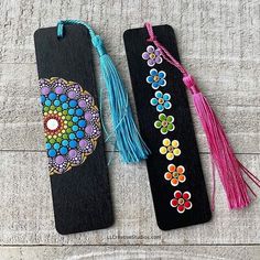 two bookmarks decorated with colorful beads and tassels on a table next to each other