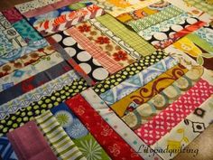 a patchwork quilt is laying on the floor