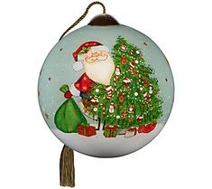 a glass ornament with a santa clause decorating a christmas tree on it