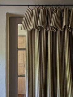 the curtains are hanging in front of an open door