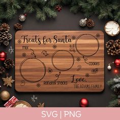 a cutting board with the words treats for santa on it next to christmas decorations and pine cones