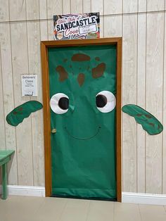 a green door with an image of a smiling face on it