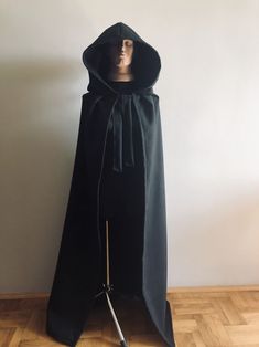 Black Wool Hooded Cloak, Wool Hooded Coat, Halloween Cape, Wool Hooded Cape, Medieval Cape, Autumn Cloak This coat is fastened with tying around the neck Please choose length Standard length is 145 cm (57 inches) Possible to produce length from the top of shoulders: 140 cm (55 inches), perfect for height 155-160 cm (61 inches - 63 inches) Price will not change for Lengths: 150 cm - 59 inches 160 cm - 63 inches 170cm - 67 inches 180cm - 71 inches Shipping terms to USA, United Kingdom, Canada - 25 Hooded Cape For Fall Cosplay, Hooded Winter Cape For Cosplay, Gothic Hooded Winter Cape, Winter Hooded Cape For Cosplay, Halloween Hooded Outerwear With Drawstring Hood, Hooded Cape For Cosplay In Winter, Halloween Cape Outerwear For Larp, Black Outerwear For Larp Halloween, Black Long Sleeve Cape For Halloween