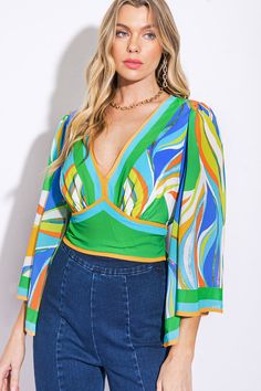 A printed woven cropped top featuring V neckline, 3/4 angel sleeve, waist yoke and smocked back waist bandDetails:Self : 100% PolyesterLining : 100% PolyesterSize & Fit- Model is 5`8" And Wearing Size Small- Measurements Taken From Size Small- Approx. Length: 18" Green Long Sleeve Tops With Elastic Sleeves, Multicolor Tops With Elastic Sleeves For Spring, Chic Green Top With Elastic Sleeves, Multicolor V-neck Tops With Blouson Sleeves, Multicolor V-neck Blouson Sleeve Tops, Chic Green Cropped Blouse, Chic Cropped Green Blouse, Trendy Green Blouse With Vibrant Print, Green V-neck Tops With Blouson Sleeves