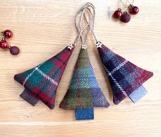 three ornaments are hanging from strings on a table