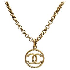 This is a beautiful and highly sought after Chanel 24K yellow gold plated CC medallion pendant necklace, circa 1993. The fluted / rope design medallion hangs on a chunky, long chain. The Details: Necklace Length: 76 cm / 30 inches Medallion / Pendant Diameter: 4.5 cm Total Necklace + Pendant Drop: 79.5 cm Material: 24k Yellow Gold Plated Base Metal Condition : Very good vintage condition. It has a lovely patina to it and has been well kept and looked after. Authenticity Report: This was inspected and authenticated by Eliza Bautista. The piece is stamped 'Chanel 93P', 'Made in France' and numbered 3097 on an oval plaque at the back of the medallion. The bolt clasp has a "CC" logo, and an oval tag is also attached, also stamped. Please see photos for more details. It will come to you package Chanel Necklace Outfit, French Modern, Chanel Box, Necklace Outfit, Chanel Necklace, Rope Design, Chunky Necklace, Cc Logo, Vintage Chanel