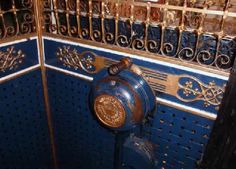 an old fashioned blue and gold urinal in a bathroom