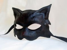 CAT MASK IN DARK LEATHER This item is available to order. Please allow three weeks before shipping. Our masks are made entirely by hand, all in genuine leather and wearable. The masks are designed not only as art objects, but also to be worn. Thanks to our special process the leather retains its elasticity allowing a good fit of the mask. The leather we luse is tanned using vegetable products. The casts of which are shaped masks are in clay and its are designed and produced by us. Thanks a lot f Handmade Gothic Masks And Prosthetics For Costume, Black Medieval Masquerade Mask For Fantasy Events, Medieval Black Masquerade Mask For Fantasy Events, Medieval Black Masks And Prosthetics For Fantasy Events, Medieval Masquerade Mask For Halloween Cosplay, Medieval Masquerade Mask For Halloween, Black Medieval Masquerade Mask, Medieval Black Masquerade Mask, Medieval Style Black Masquerade Mask