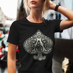 a woman wearing a black t - shirt with an ace playing card design on it