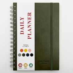 a spiral notebook with the words diary planner written on it and various color options for each page