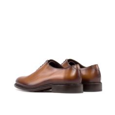 Often considered the most formal men's shoe available, the Wholecut features closed channel lacing and is made from a single cut of leather. The sleek design and limited stitching make for an elegant and highly sought-after style. The Details: Materials: cognac box calf Sole: cognac leather sole with rubber buttons injections Last: Zurigo - Rounded toe for traditional English Look What is Fast Lane? Fast lane is our new experimental 7 day made to order collection, an ambitious never been heard o Timeless Business Derby With Stitched Sole, Business Oxfords With Stitched Sole And Almond Toe, Business Oxfords In Calf Leather With Plain Toe, Formal Oxfords With Stitched Sole In Calf Leather, Timeless Formal Derby Shoes With Stitched Sole, Timeless Formal Derby With Stitched Sole, Elegant Cognac Monk Strap Business Shoes, Elegant Cognac Monk Strap Shoes For Business, Timeless Brown Derby For Business