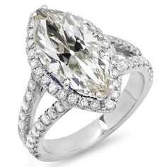 a pear shaped diamond ring with diamonds around the band and sidestones on each side