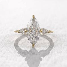 an engagement ring with three pear shaped diamonds