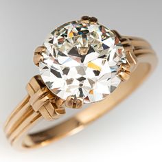 an antique diamond ring is shown on a white background, with gold accents and diamonds in the band