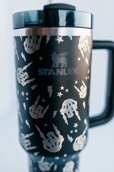 a black and white travel mug with stars on it