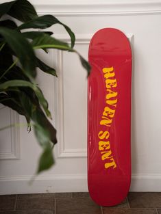 a red skateboard leaning up against a wall