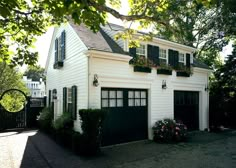 a white two story house with black shutters