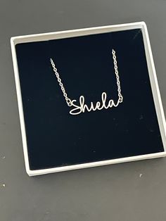 This necklace features a Dainty Sterling Silver Personalized Name Necklace with Chain. You can have your own name or word made. All carving will be made in the font as the photo.  This name necklace and chain are dainty. DIMENSIONS Width - 2.3cm  Height - 0.3cm Total Weight - 3 gram Chain Size - 1.2mm This Jewellery comes in a box ready for gifting.  Please select necklace length from the drop-down box during check out. You may choose to buy Name+Chain or just our Chain without the name in the o Customizable Silver Chain Necklace For Gift, Customized Letter Necklaces, Customizable Silver Signature Necklace, Silver Letter Name Necklaces, Silver Custom Name Signature Necklace, Silver Signature Custom Name Necklace, Signature Silver Custom Name Necklace, Silver Signature Necklace With Custom Name, Custom Name Silver Letter Necklace