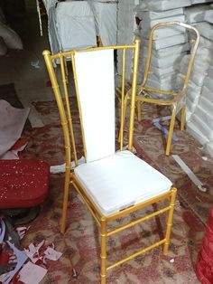 two white chairs sitting next to each other in a room