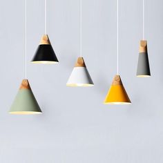 five different colored lamps hanging from the ceiling