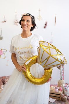 a woman is holding two balloons in her hands