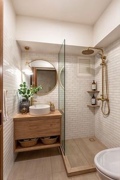 a bathroom with a sink, mirror and shower in it's corner area next to a toilet