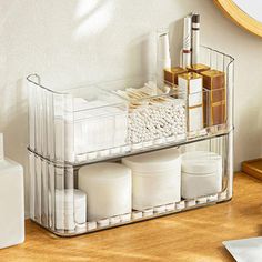 an organized bathroom shelf with toiletries on it