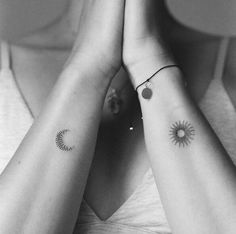 two women with matching tattoos on their arms