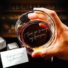 a person holding a glass with writing on it next to some ice cubes and a note that says thank you for being my girlfriend