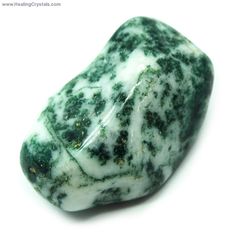 a green and white stone sitting on top of a table