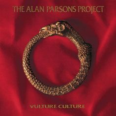 a gold snake ring on top of a red sheet with the words, the alan parsons project vulture culture