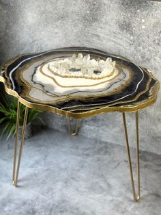 a black and white table with gold legs