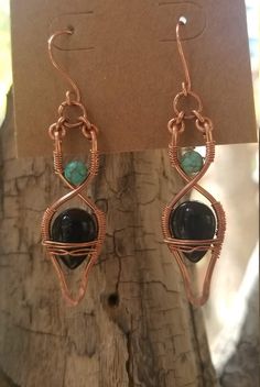 I created these earrings utilizing cold forging and wire-weaving techniques. To add some color to these earrings I incorporated pieces of turquoise and black glass. Artisan Black Jewelry With Ear Wire, Artisan Black Dangle Earrings, Black Artisan Earrings, Handmade Black Copper Earrings, Black Artisan Drop Earrings, Artisan Black Drop Earrings, Black Copper Dangle Earrings, Black Wire Wrapped Drop Earrings, Unique Black Wire Wrapped Earrings