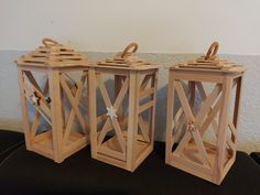 two wooden lanterns sitting on top of a table