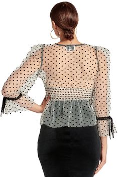 Back picture of model wearing white mesh black polka dot 3/4 puff sleeve peplum hem v-neck top with black velvet buttons and bows. Party Tops With Polka Dot Swiss Dot, Fitted Long Sleeve Tops With Swiss Dot, Fitted Long Sleeve Top With Swiss Dot Details, Fitted Swiss Dot Tops For Fall, Fall Party Blouse With Swiss Dot Details, Elastic Shirring, Top With Puff Sleeves, Teal Velvet, Stylish Top