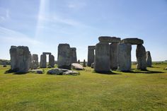 the stonehenge monument stands in an open field