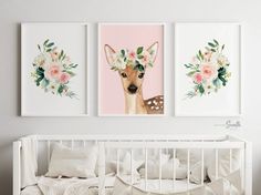 two deer pictures hanging on the wall above a crib