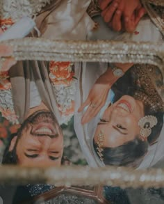 the bride and groom are looking at each other in their wedding day photo taken through a mirror