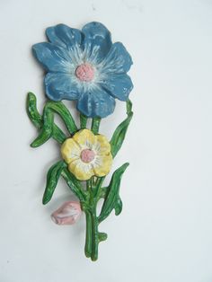 This cheerful enamel flower brooch  was probably made in the late 1930s or early 40s. This came to me with a lot of damage to the enamel so it has been to the spa and come back with entirely new coat of enamel paint,  and sealer making it ready to be worn again. This pretty flower brooch measures 3.25  inches or 8.5 cm from top to bottom and it is 1.5 inches or 4 cm wide. The back of the brooch is marked BM. But this is maker I can not find any information on.  This brooch was not make with a roll over safety catch but has instead a c catch. I291 Classic Necklace, Cat Brooch, Enamel Paint, Enamel Flower, Orange Cat, Enamel Jewelry, Flower Brooch, Pretty Flowers, Blue Flowers