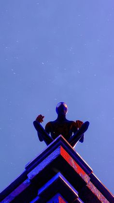 a man standing on top of a tall building next to a sky filled with stars