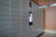 an elevator in a public building with wooden walls and tile flooring on either side