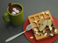 a waffle on a red plate next to a cup of coffee and some cinnamon sticks