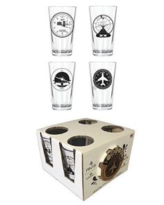 four shot glasses sitting in front of each other on top of a cardboard box,