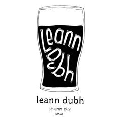 a beer glass with the words leann dubh written in white ink on it